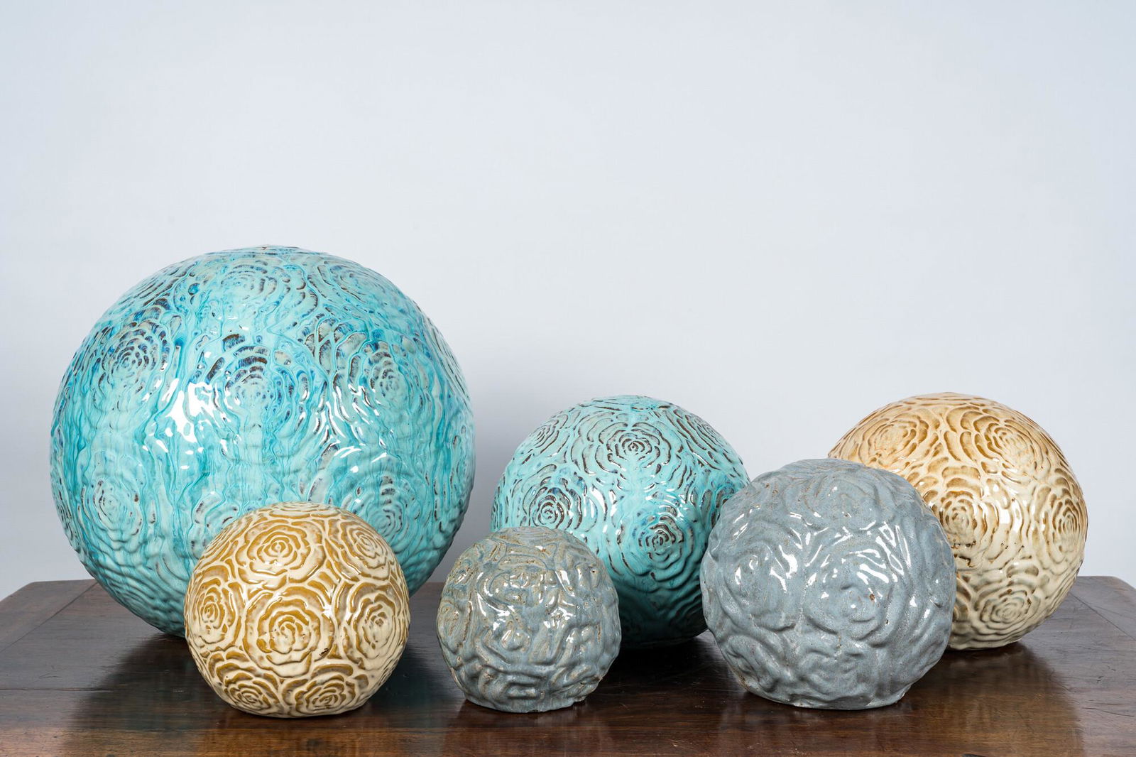 Six glazed terracotta spheres with floral relief design, 20th C. (1 of 3)