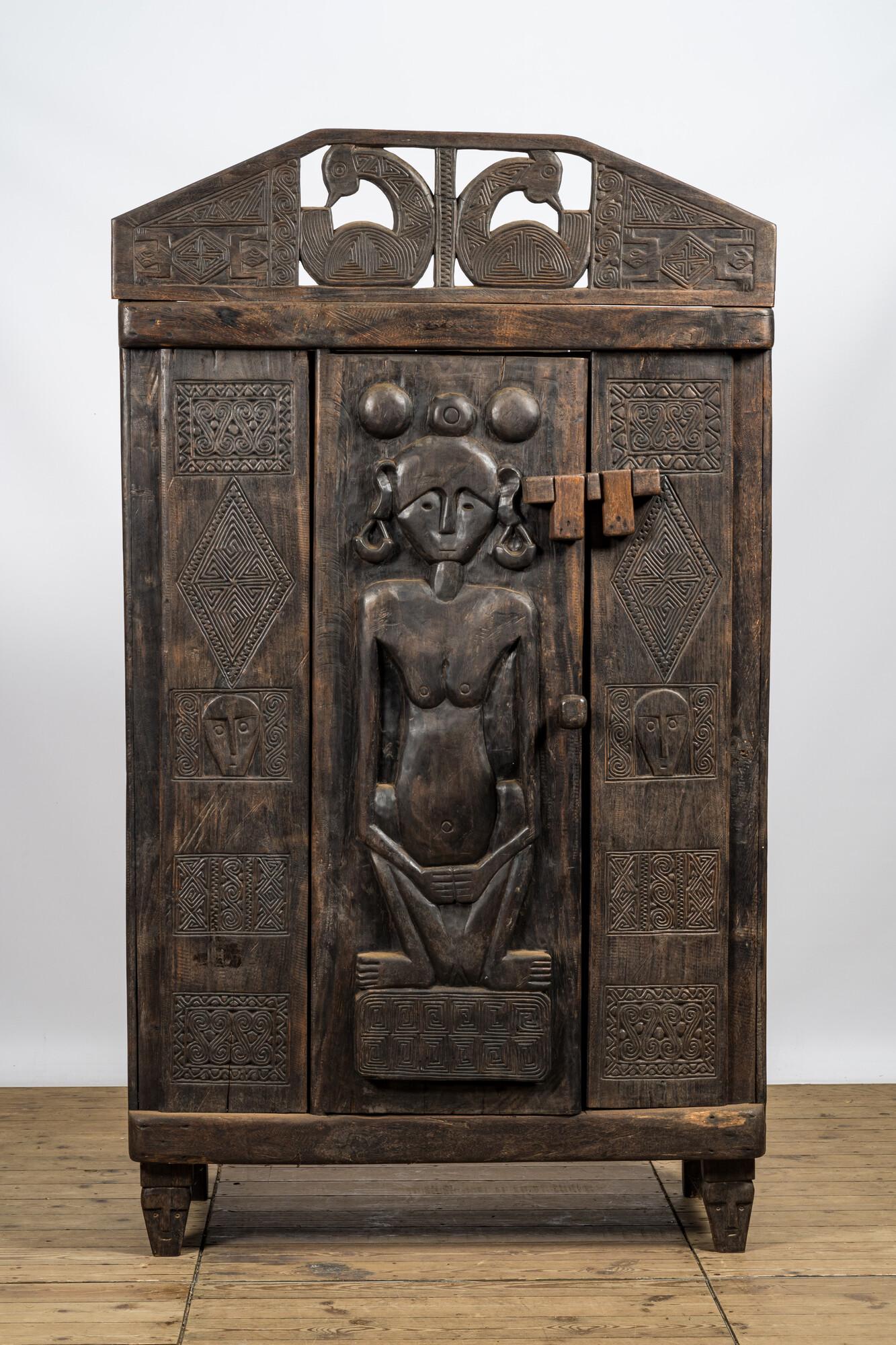 A decorative wooden African-inspired single-door cupboard, 20th C. (1 of 4)