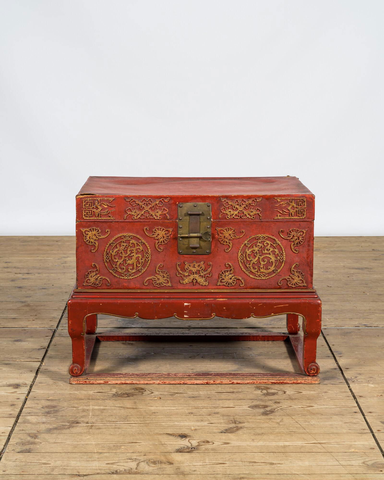 A Chinese red lacquered bronze-mounted travel trunk on foot, 20th C. (1 of 5)