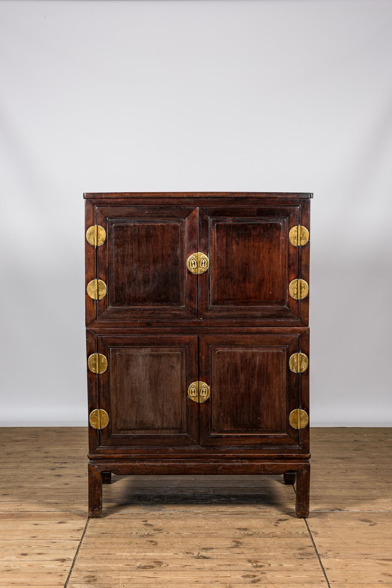 A Chinese four-door wooden brass mounted cabinet, 20th C. (1 of 3)