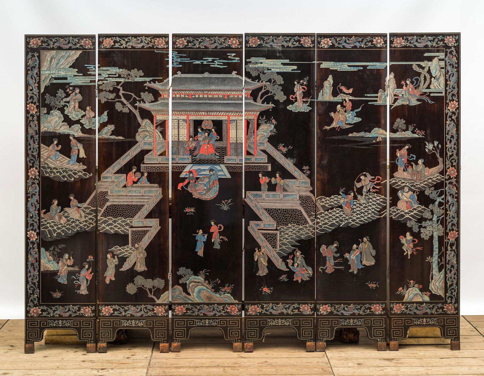 A Chinese lacquered six-part folding screen with a narrative 'immortals' scene, 20th C. (1 of 9)