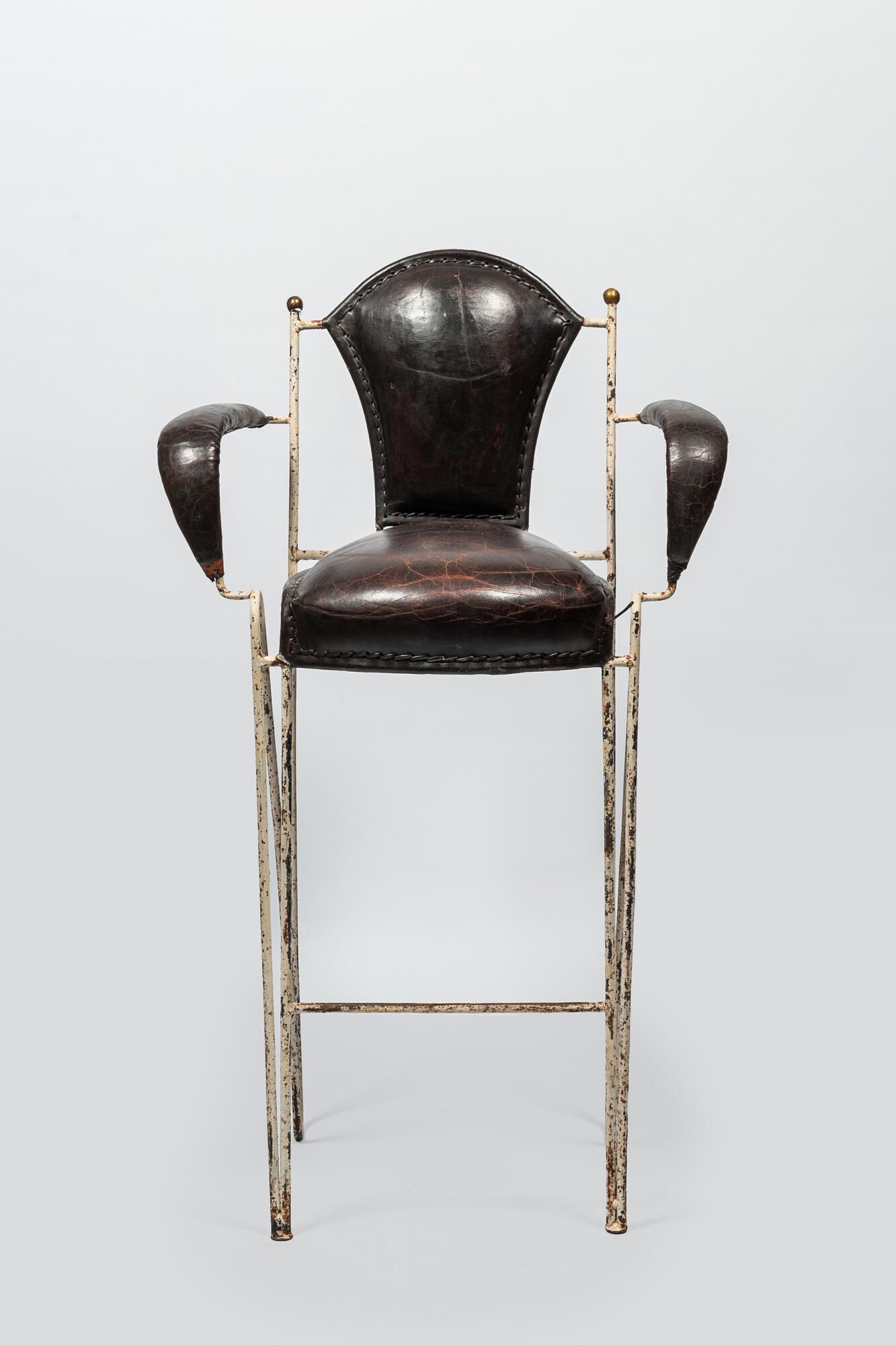 A decorative bar chair in leather and patinated metal, 20th C. (1 of 2)