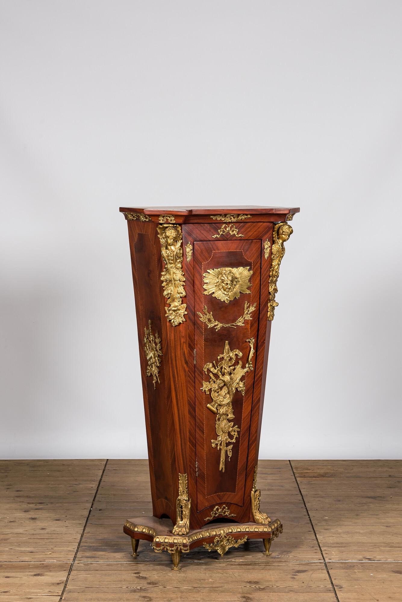 A French Louis XVI-style gilt bronze mounted wooden pedestal in the manner of Jean-Henri Riesener,: Full title: A French Louis XVI-style gilt bronze mounted wooden pedestal in the manner of Jean-Henri Riesener, 20th C. Description: H 143,5 x L 67 x D 48 cm About this sale: Paul De Grande is one of t