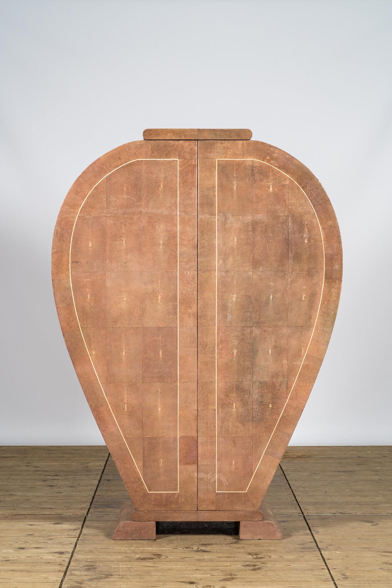 A light pink leather-clad two-door cabinet, 20th C. (1 of 3)