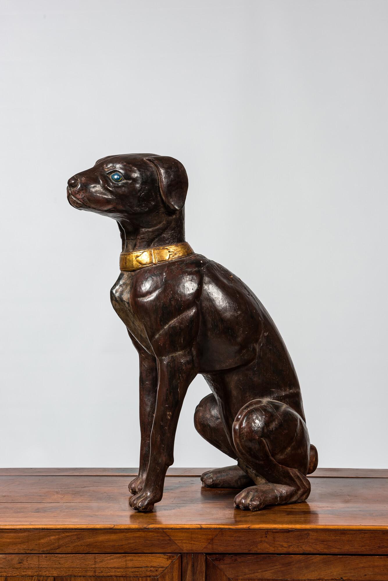 A large polychrome wooden sculpture of a dog, 1st half 20th C. (1 of 3)