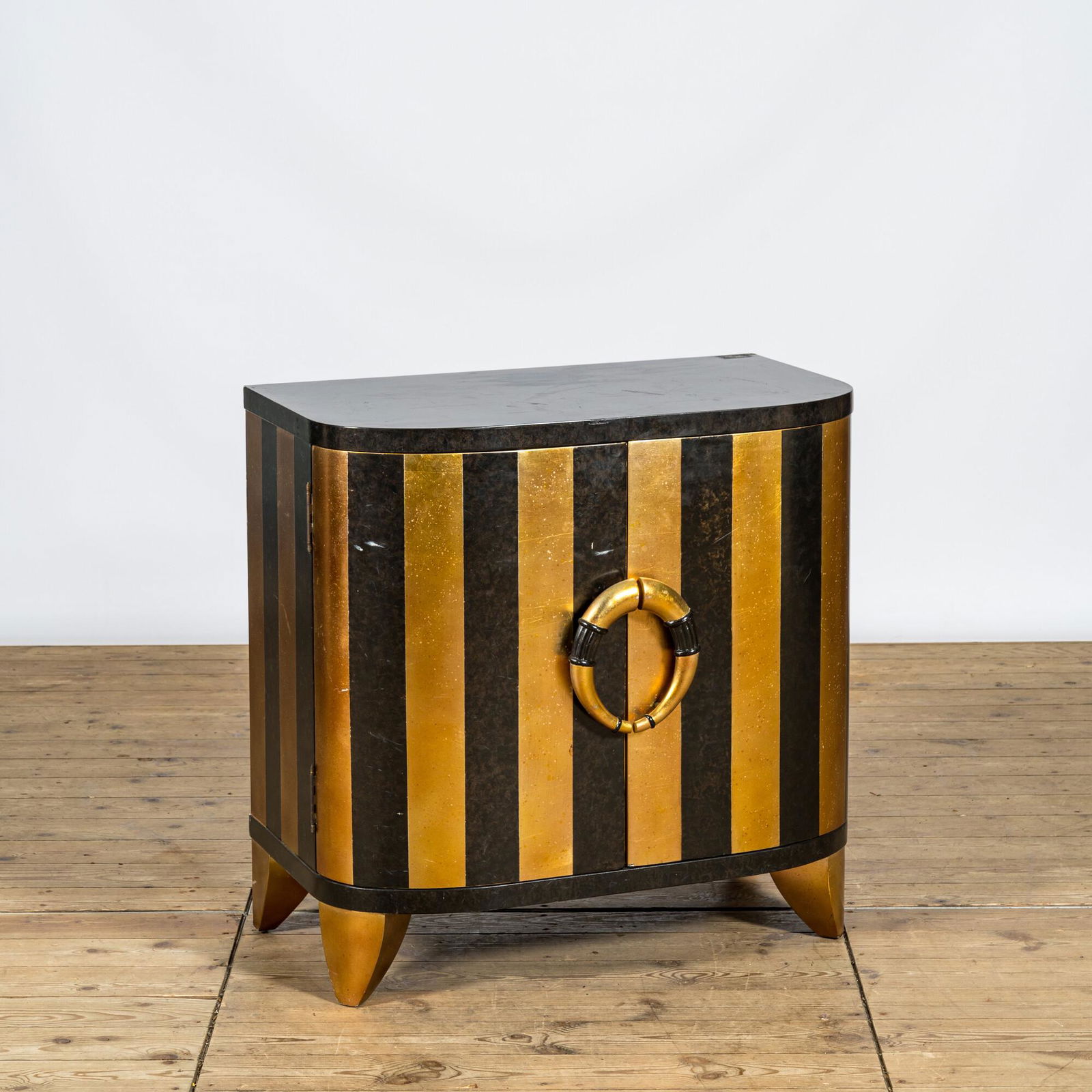 A curved black and gilt lacquered wooden two-door cabinet, 20th C. (1 of 3)