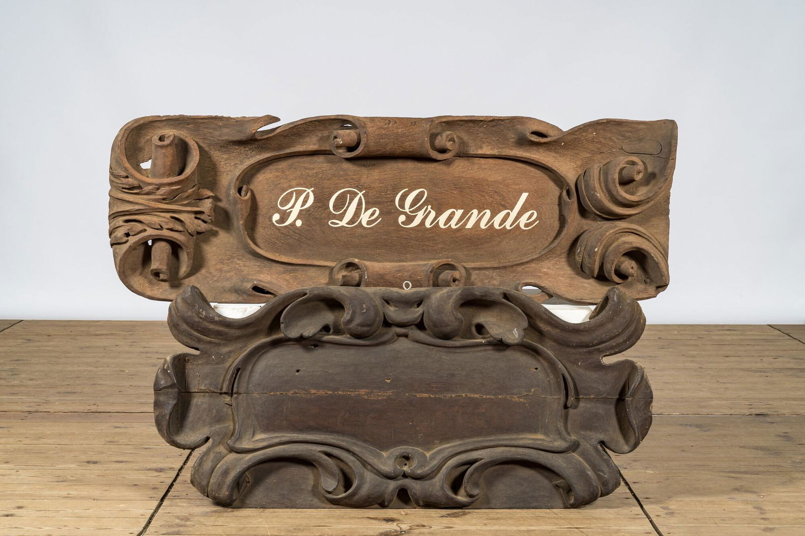 A pair of wooden signboards of which one bearing the name P. De Grande, 20th C. (1 of 1)