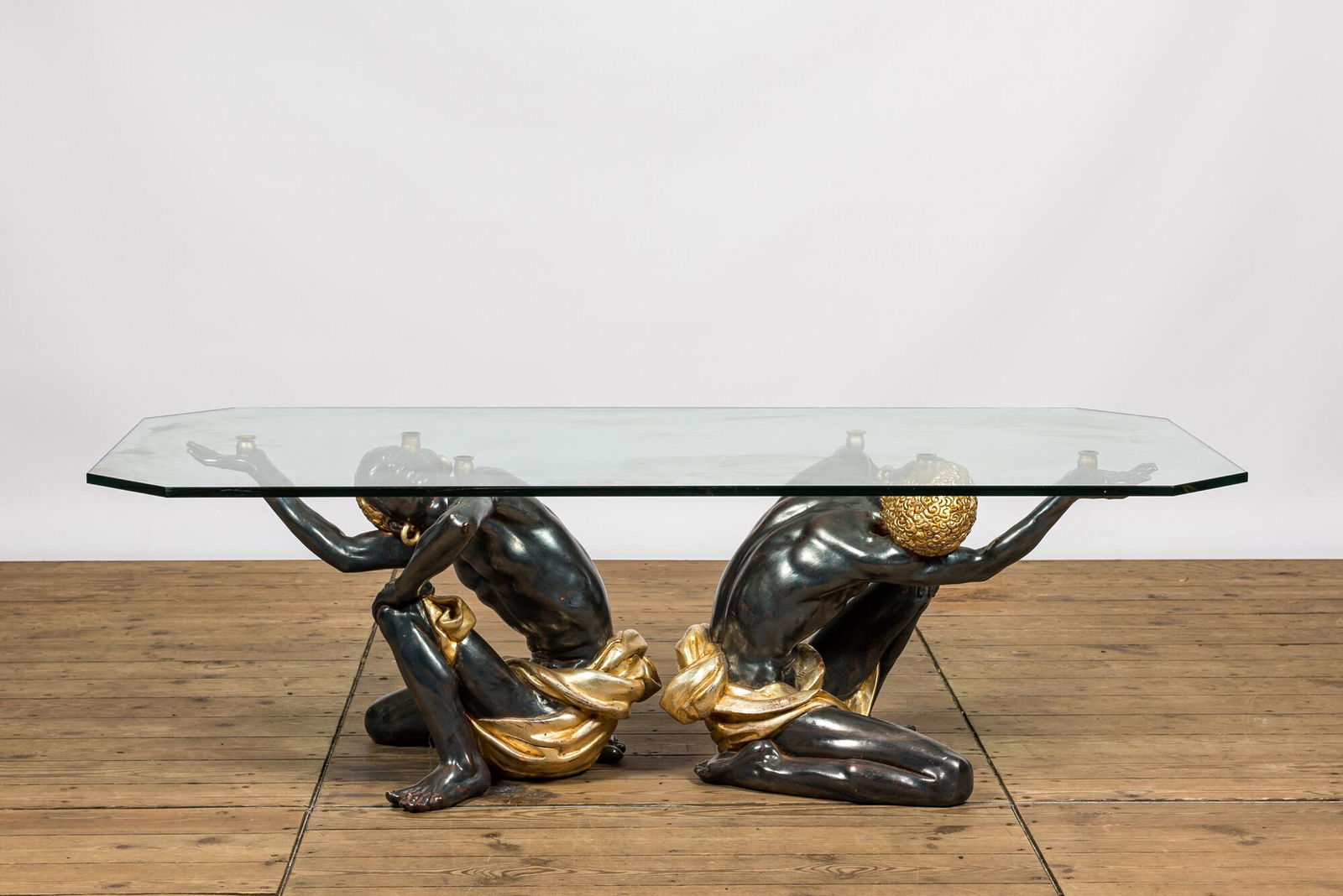 A coffee table with a glass top resting on two Moorish figures in polyester, Italy, 2nd half 20th (1 of 3)