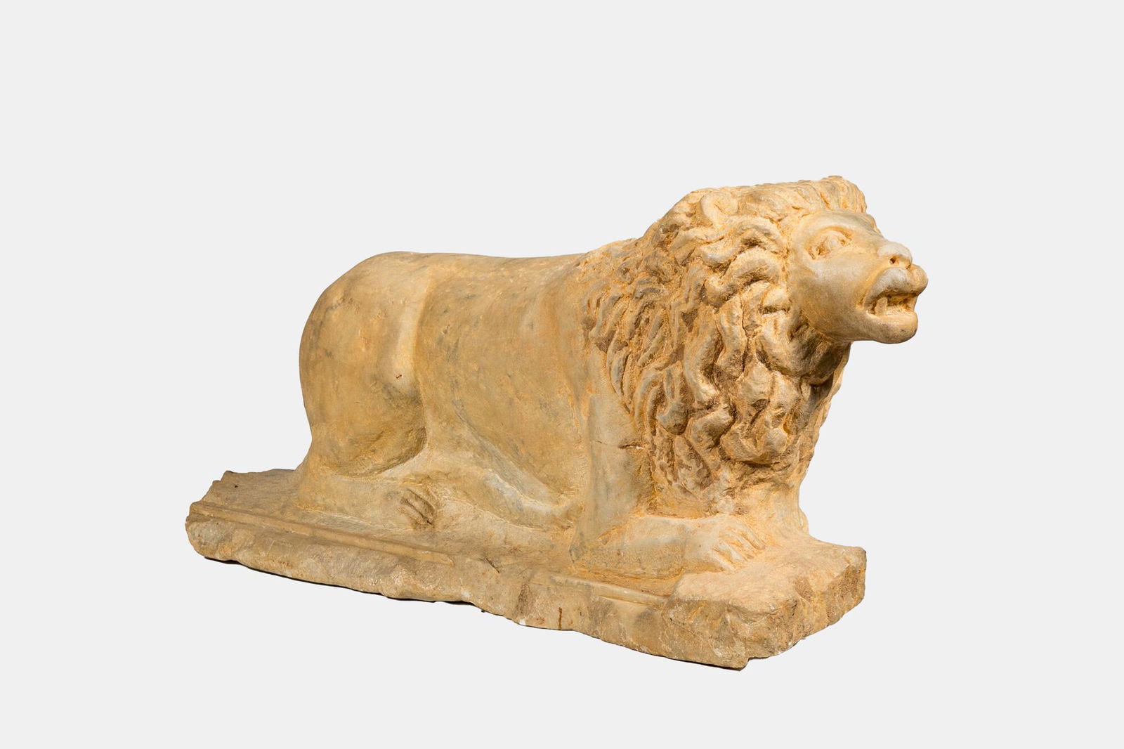A marble model of a reclining lion, 20th C. (1 of 3)