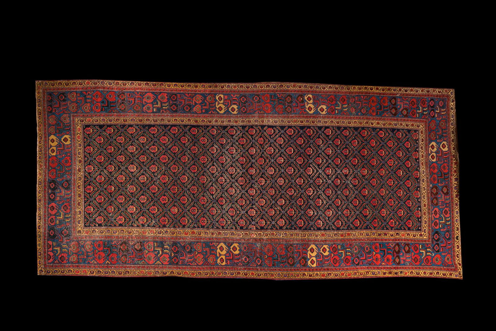 An Oriental rug with geometric motifs and floral design, wool on cotton, 20th C. (1 of 6)
