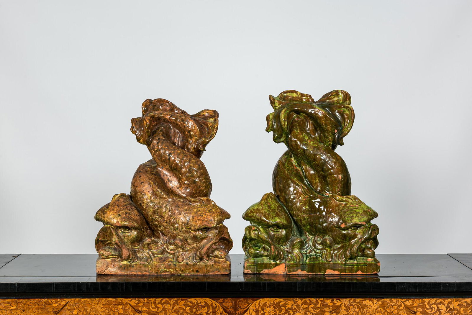 A pair of large Italian glazed terracotta sculptures of entwined dolphins, 20th C. (1 of 4)
