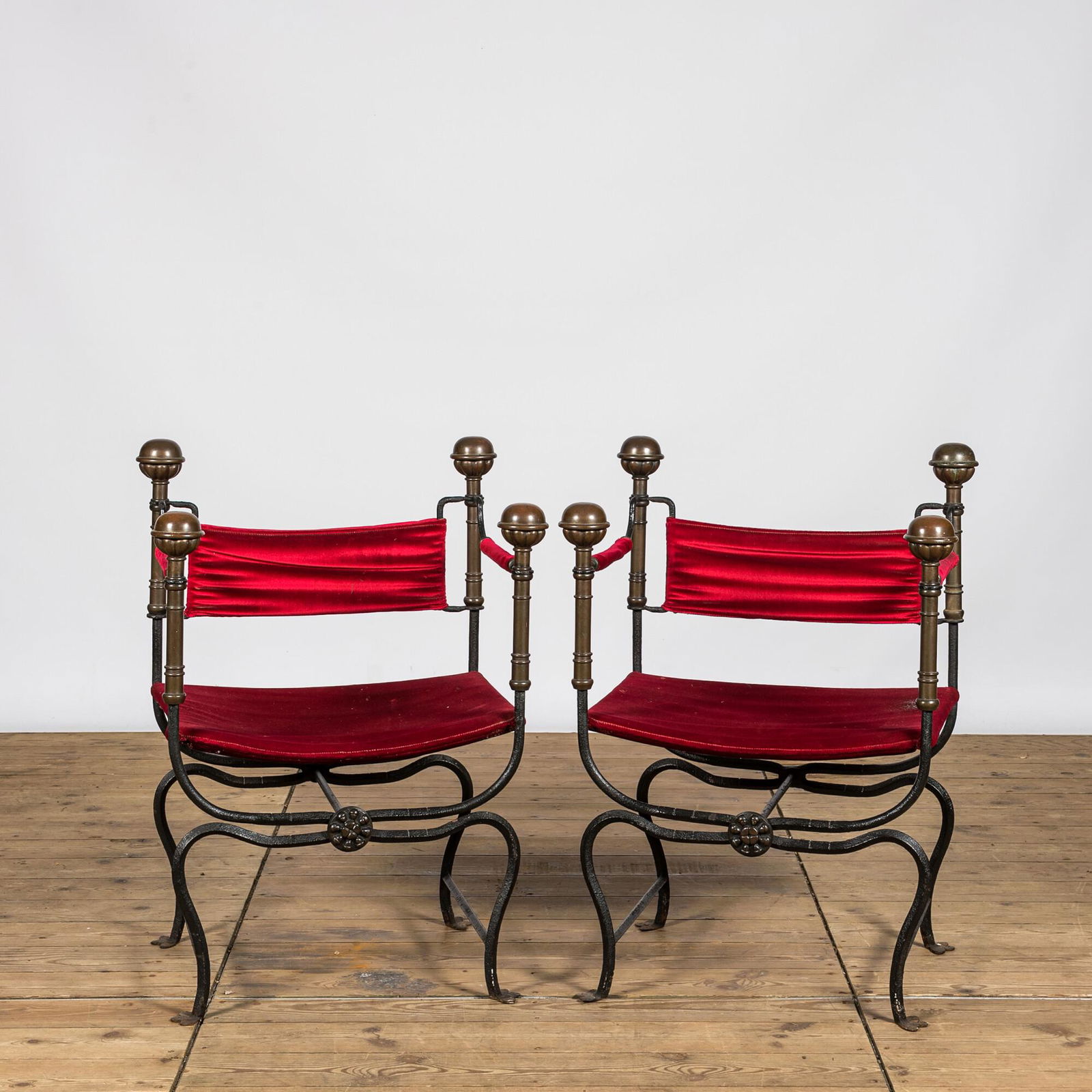 A pair of Italian wrought iron Savonarola chairs with brass mounts and velvet upholstery, 20th C. (1 of 3)