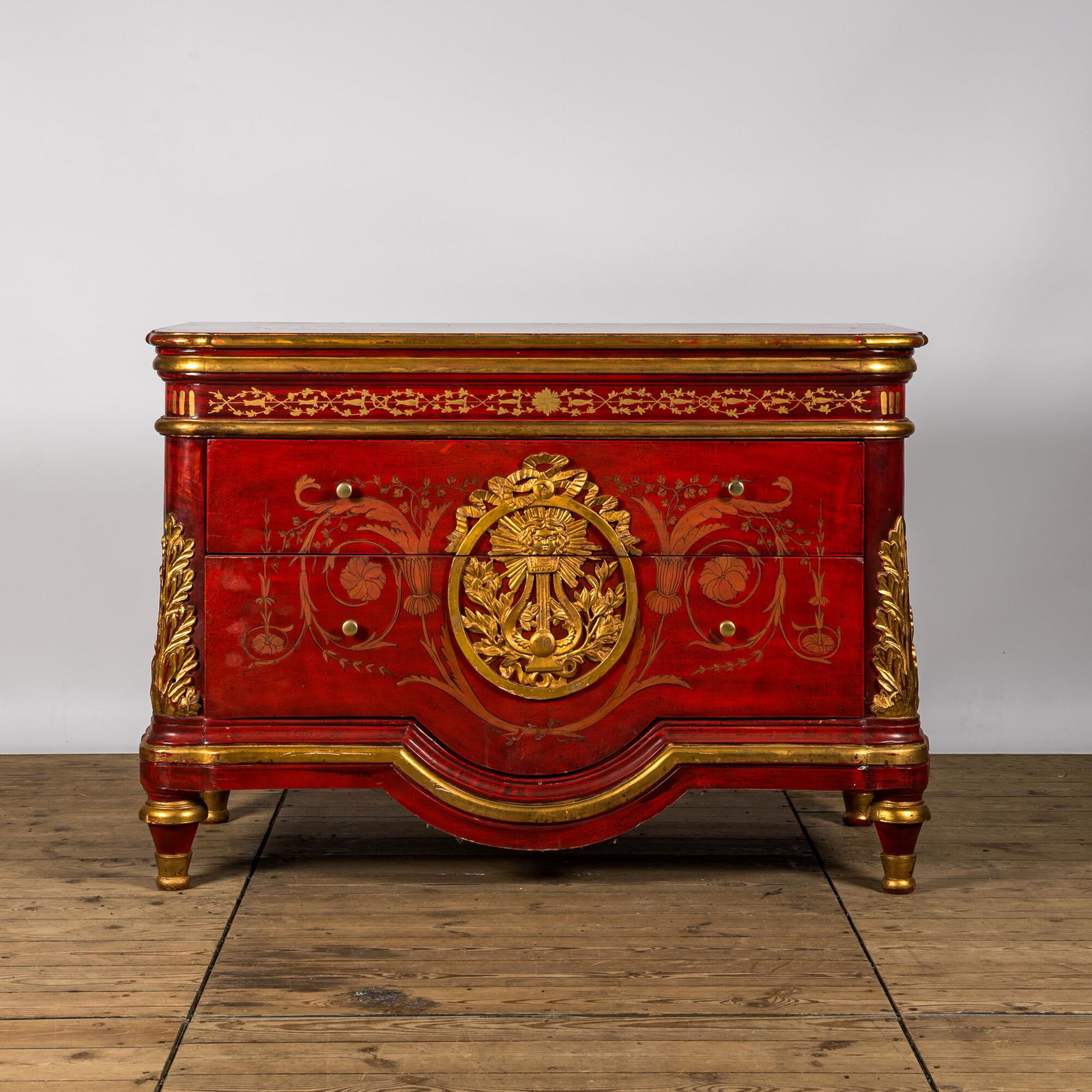 A red lacquered and gilt chest of drawers, 20th C. (1 of 3)