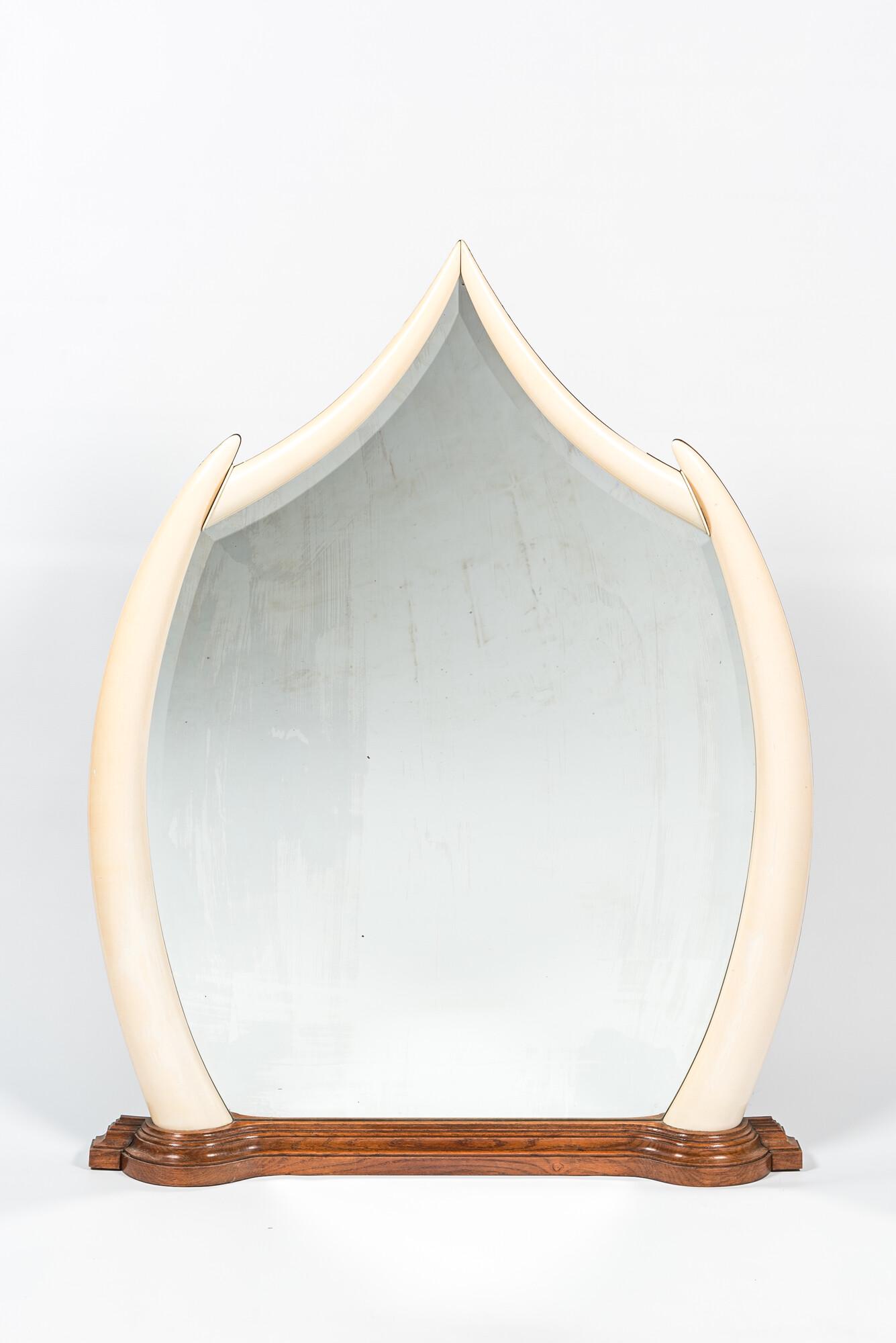 A large mirror set in faux ivory tusks, 20th C. (1 of 1)