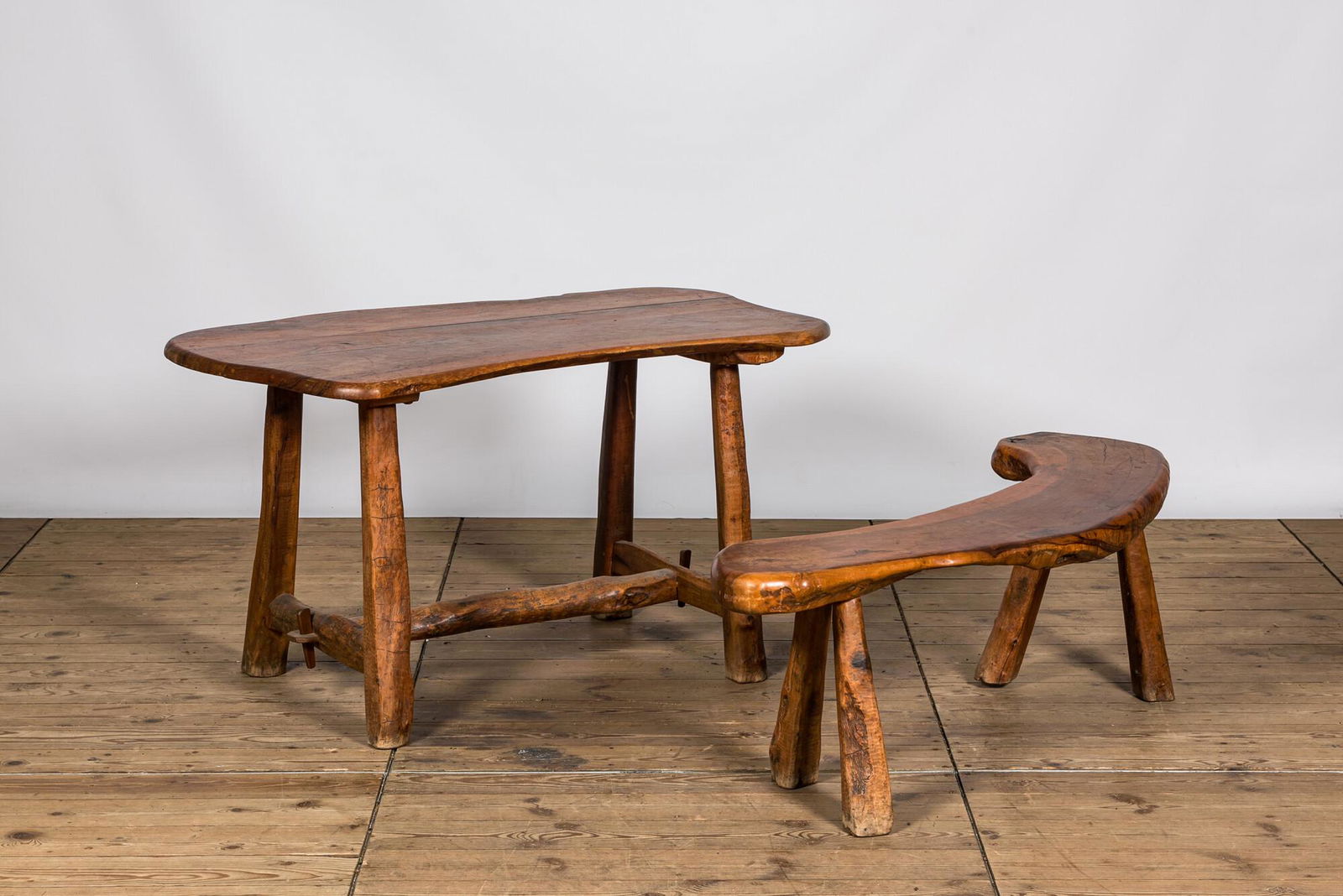 A rural hardwooden garden table with matching bench, 20th C. (1 of 2)
