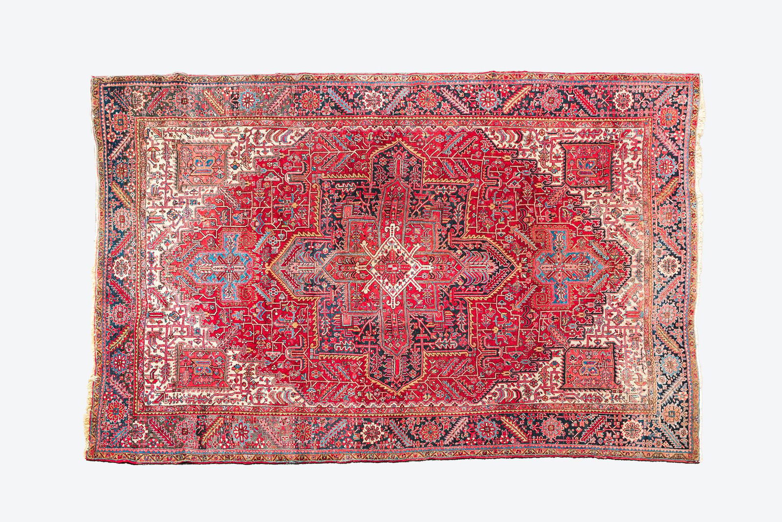 A Persian Heriz rug with floral design and geometric motifs, wool on cotton, 20th C. (1 of 3)