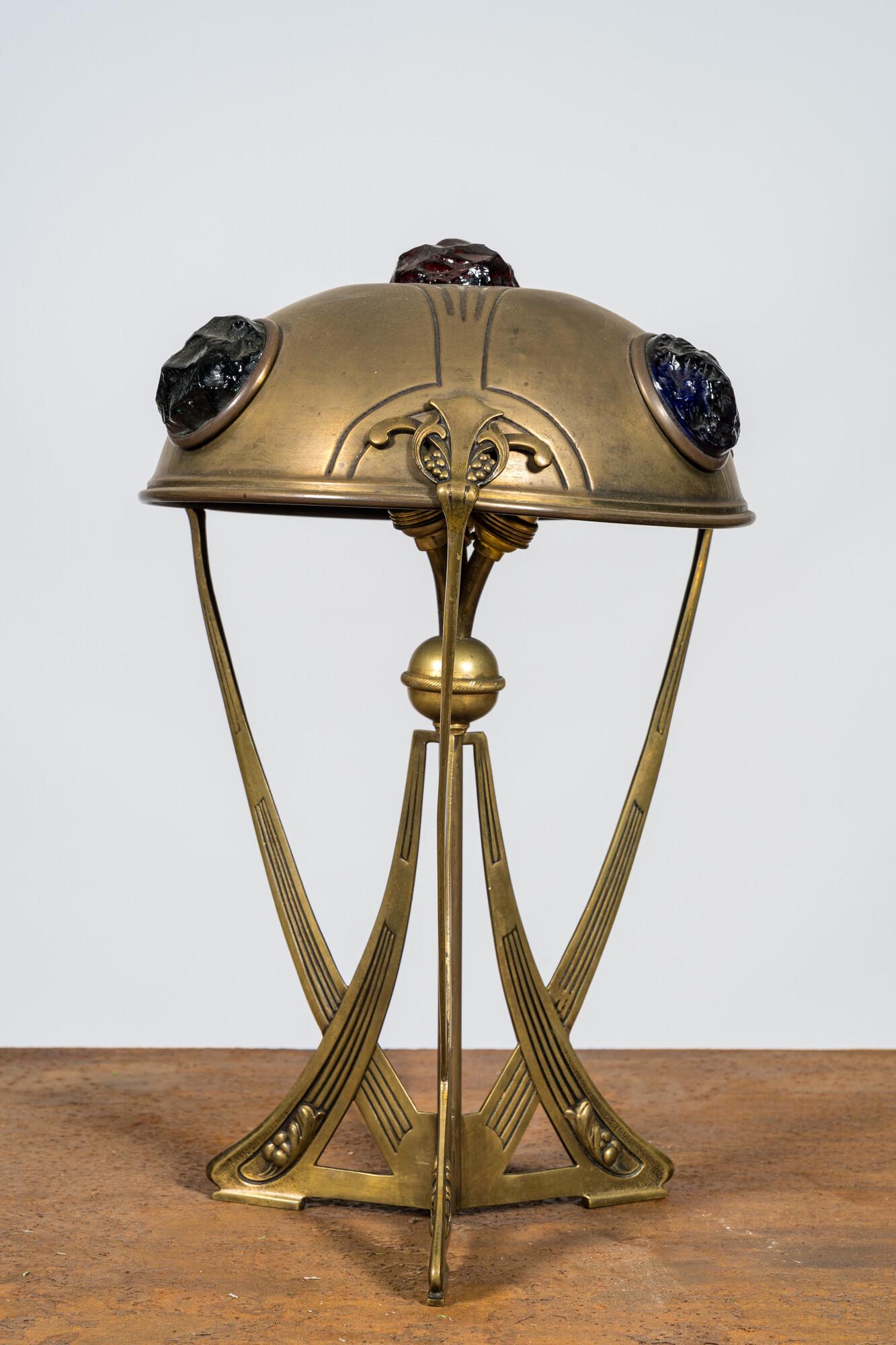 An Art Nouveau brass lamp with coloured cabochons, 20th C.: Full title: An Art Nouveau brass lamp with coloured cabochons, 20th C. Description: H 39,5 cm About this sale: Paul De Grande is one of the major dealers of antique furniture, fine sculptures and deco