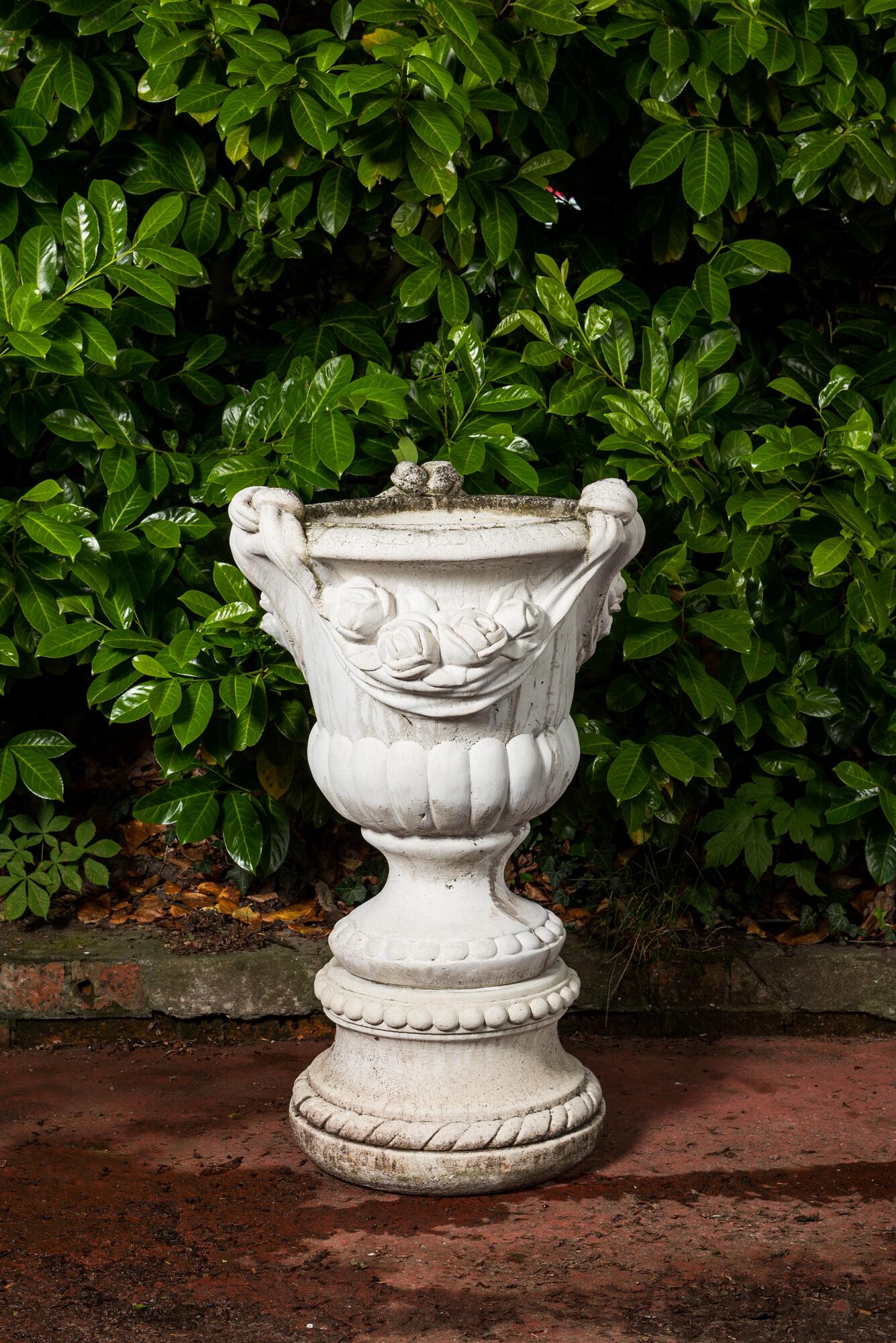 A white painted concrete garden urn on stand, 20th C. (1 of 4)