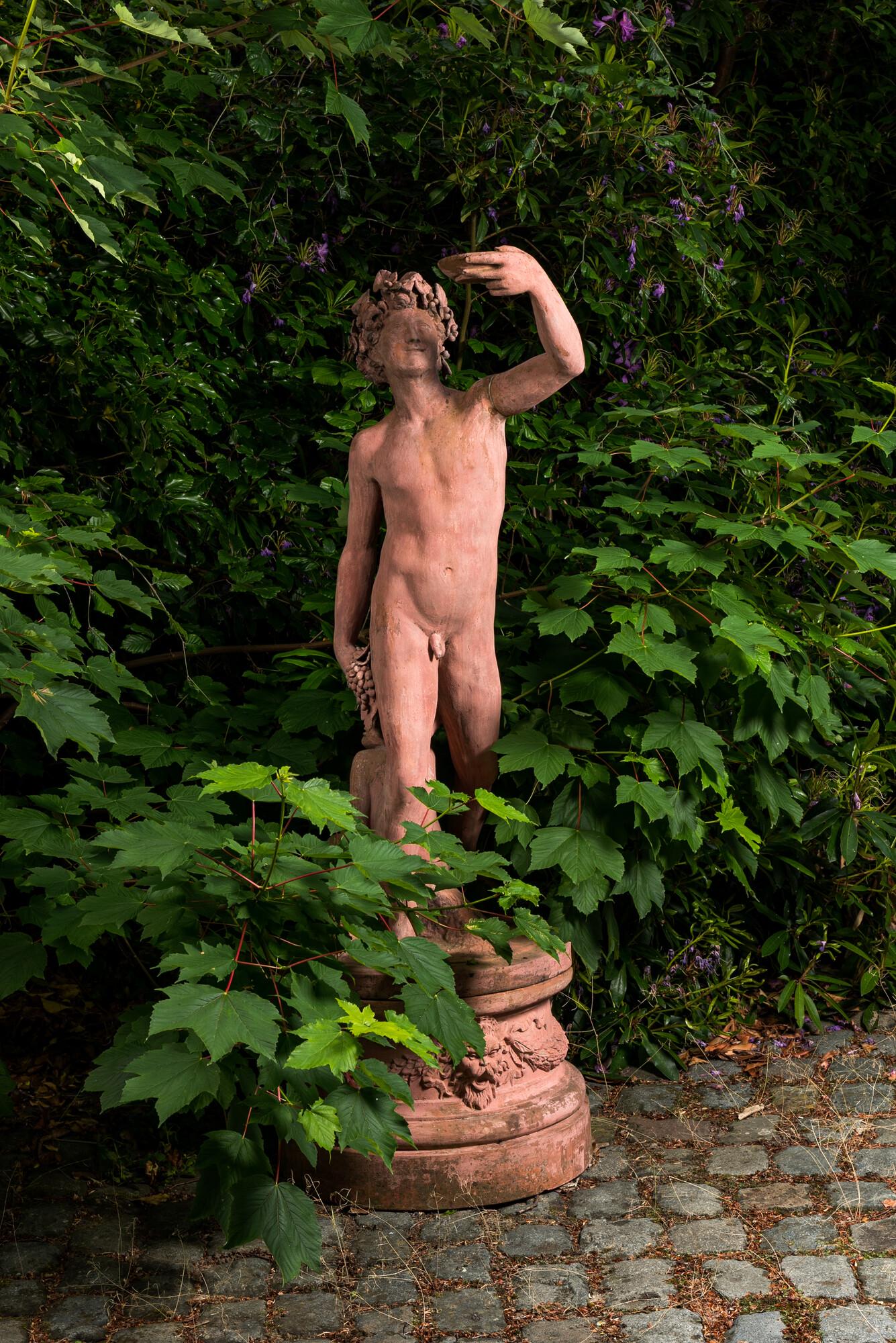 A large patinated terracotta sculpture of a bacchant with a young satyr, 20th C. (1 of 4)