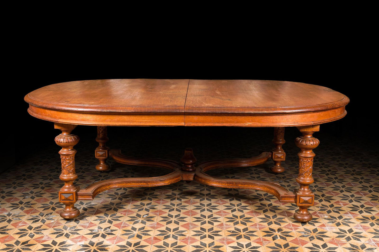 A large oval wooden table on carved baluster-shaped legs, early 20th C. (1 of 5)