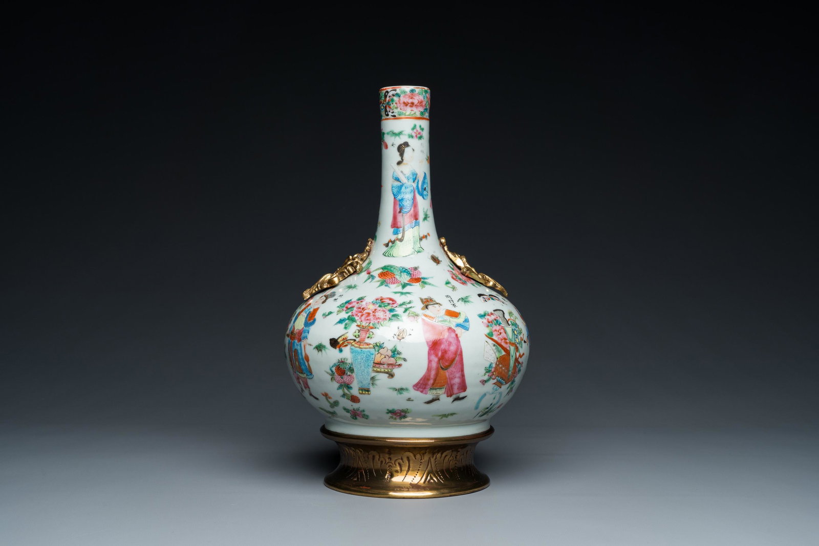 A Chinese Canton famille rose vase with gilt brass mounts, 19th C.: H.: 34,5 cm (incl. mount) H.: 29 cm (the vase) Condition: (UV-checked) - A few baking spots to the rim and a baking flaw below the rim. - Some losses of the overglazed enamel design. 品相&