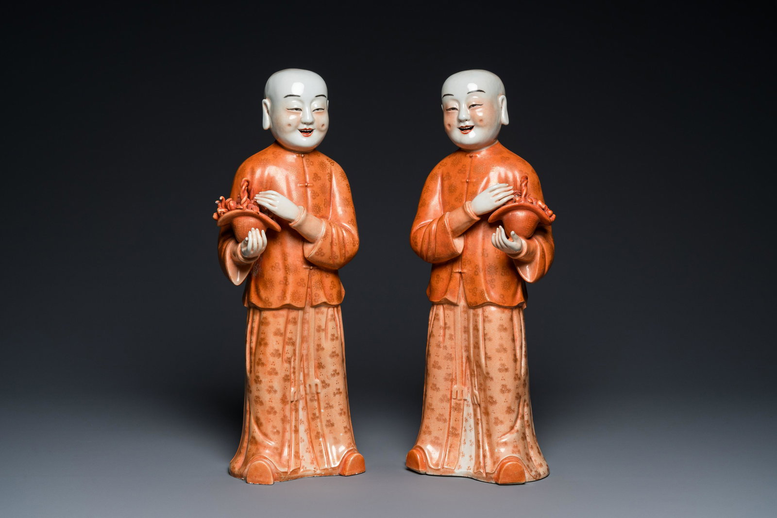 A pair of Chinese coral red 'Hehe Er Xian' sculptures, probably Jiaqing: H.: 42,5 cm