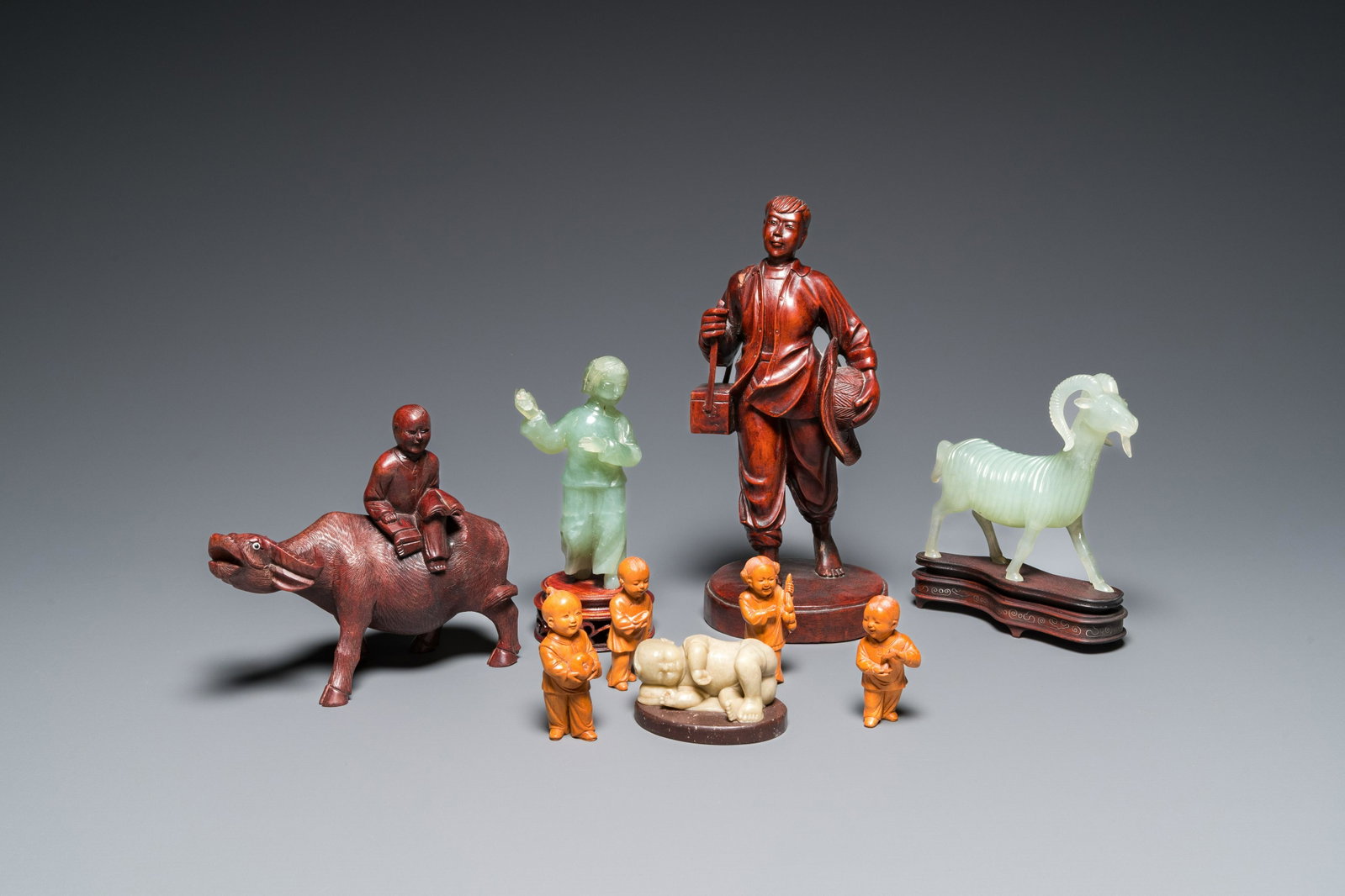 Nine Chinese Cultural Revolution sculptures in wood, jade and soapstone: H.: 27 cm (the tallest wooden figure) H.: 7,5 cm (the tallest of the four boys)