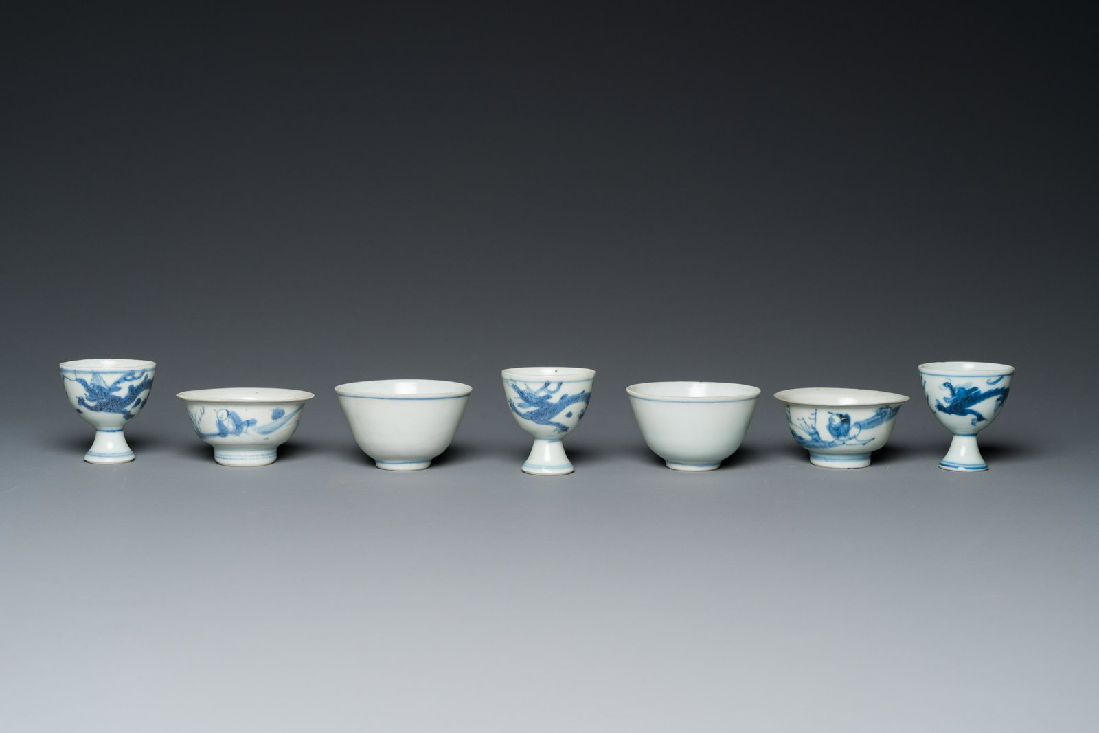 Four Chinese blue and white 'Hatcher cargo' bowls and three stem cups, Transitional period (1 of 7)
