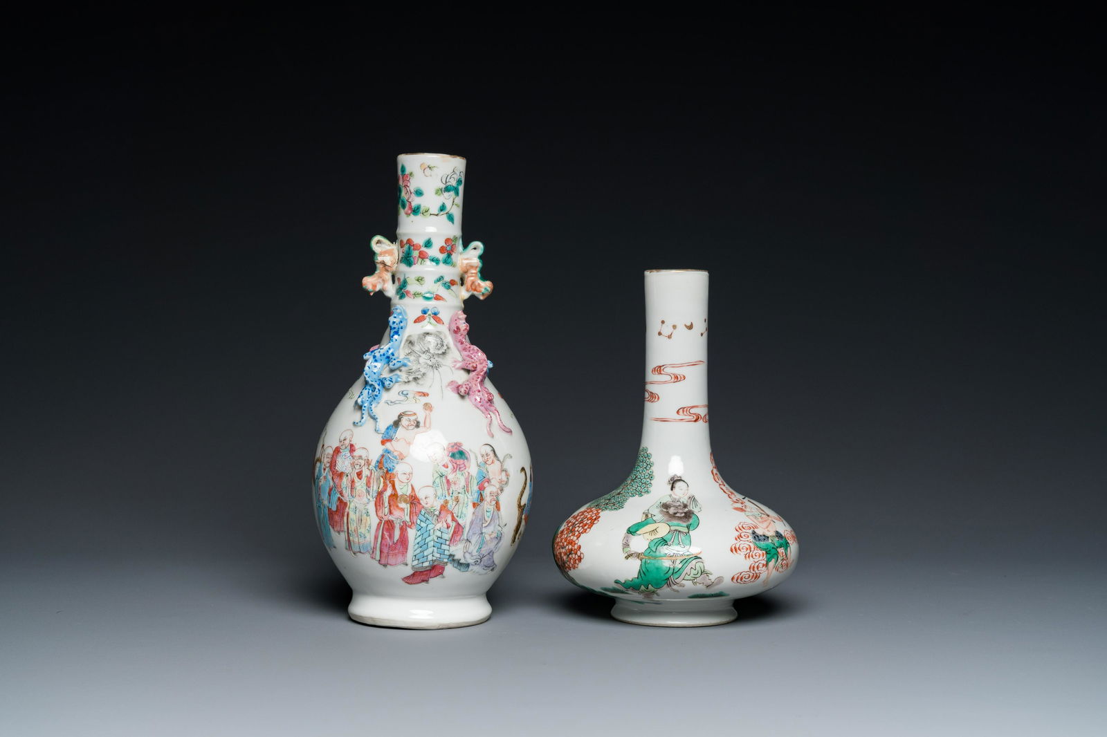 A Chinese famille rose '18 Luohan' bottle vase and a famille verte vase, Kangxi mark, 19th C.: Full title: A Chinese famille rose '18 Luohan' bottle vase and a famille verte vase, Kangxi mark, 19th C. Description: H.: 25 cm (the tallest)