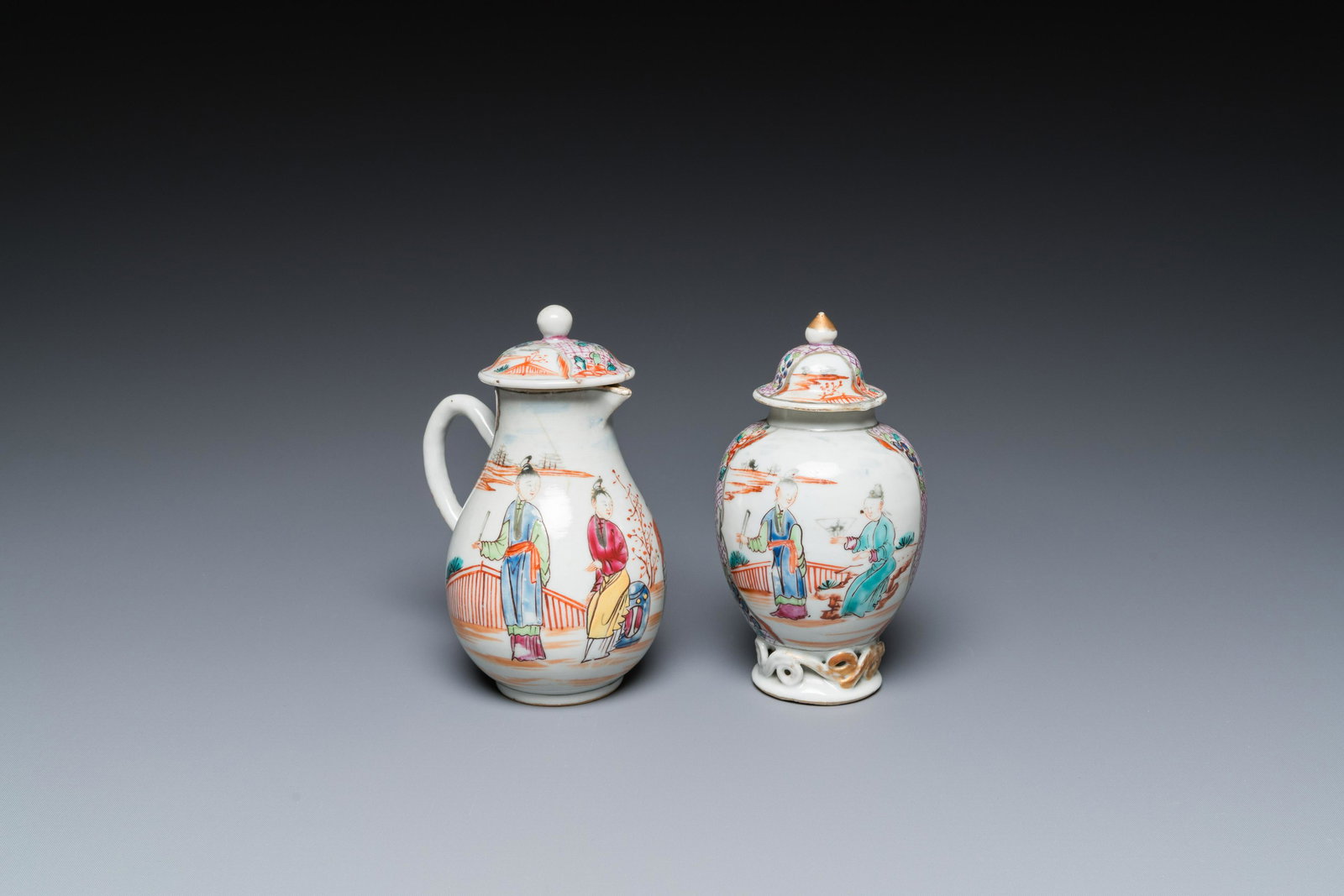 A Chinese famille rose 'mandarin subject' jug with cover and a tea caddy, Qianlong: Full title: A Chinese famille rose 'mandarin subject' jug with cover and a tea caddy, Qianlong Description: H.: 13,5 cm - L.: 10 cm (the jug)