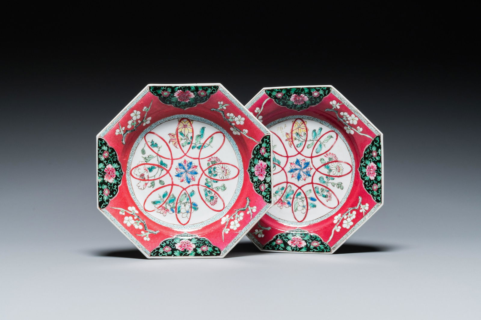 A pair of Chinese octagonal famille rose ruby-ground plates, Yongzheng (1 of 3)