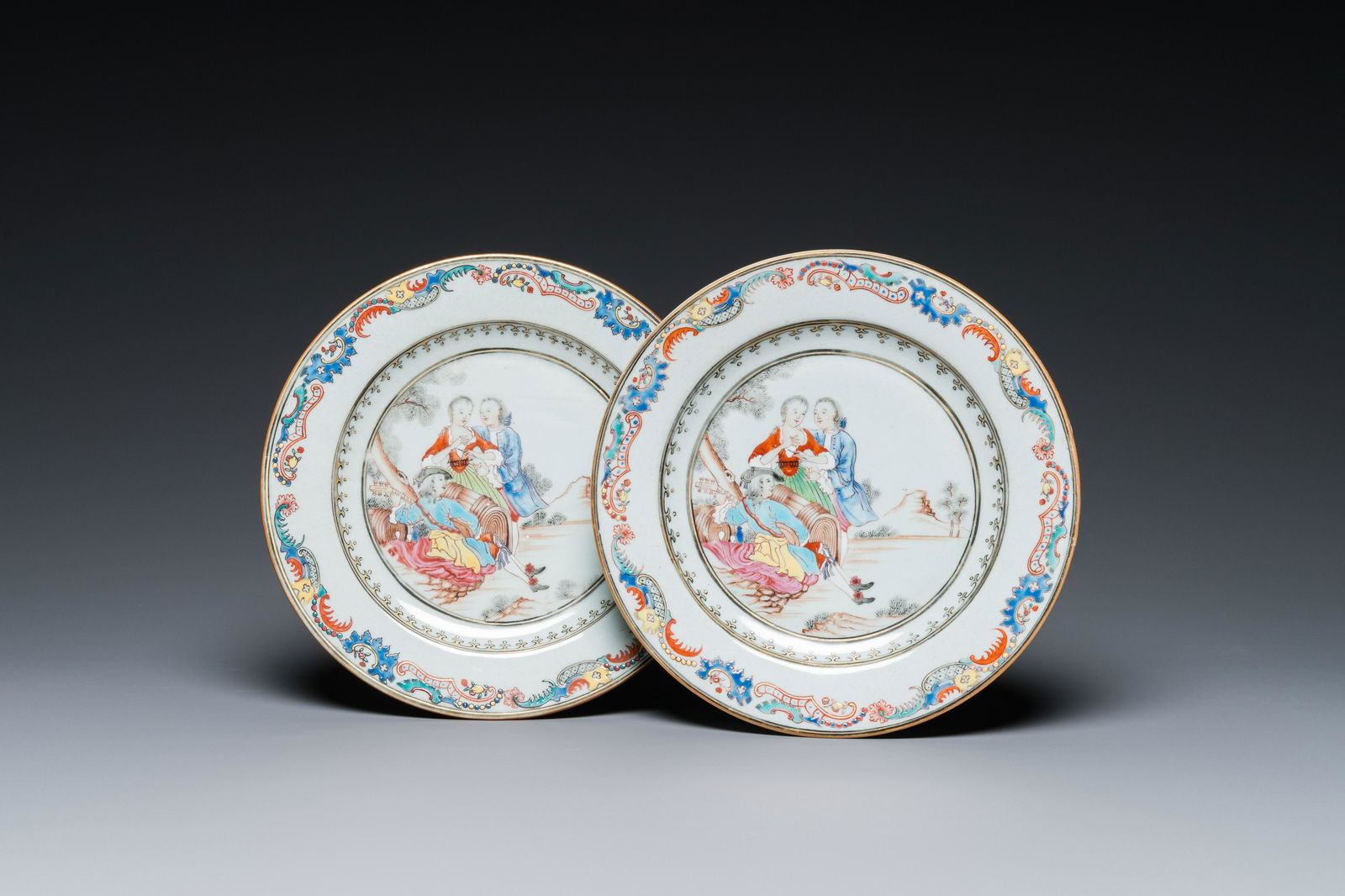 A pair of fine Chinese famille rose plates with a musician playing in front of a couple, Qianlong (1 of 3)