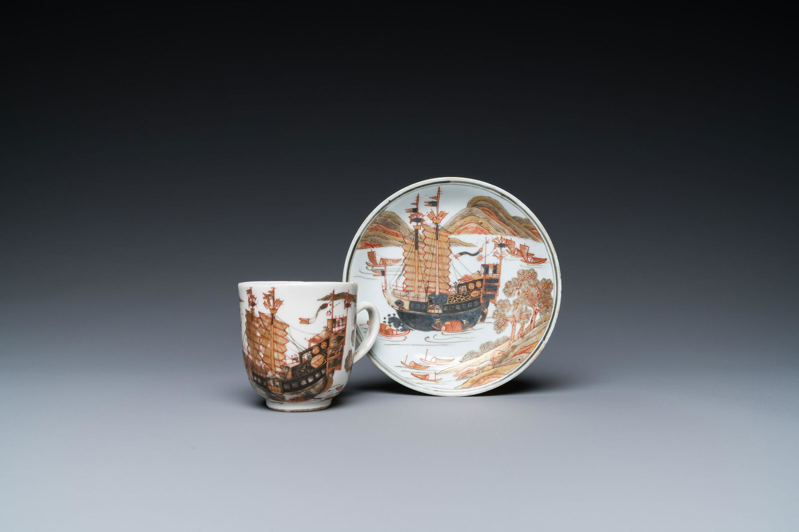 A rare Chinese gilt, grisaille and iron-red cup and saucer with a merchant vessel, (1 of 9)