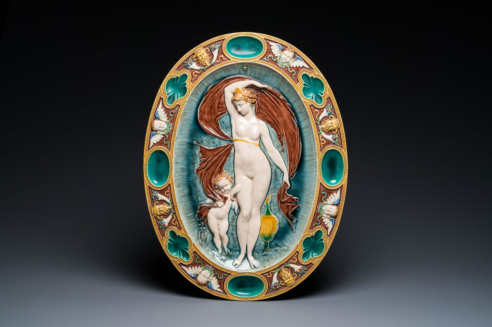 An oval Mintons majolica dish with a goddess with putto, England, year mark 1874 (1 of 3)
