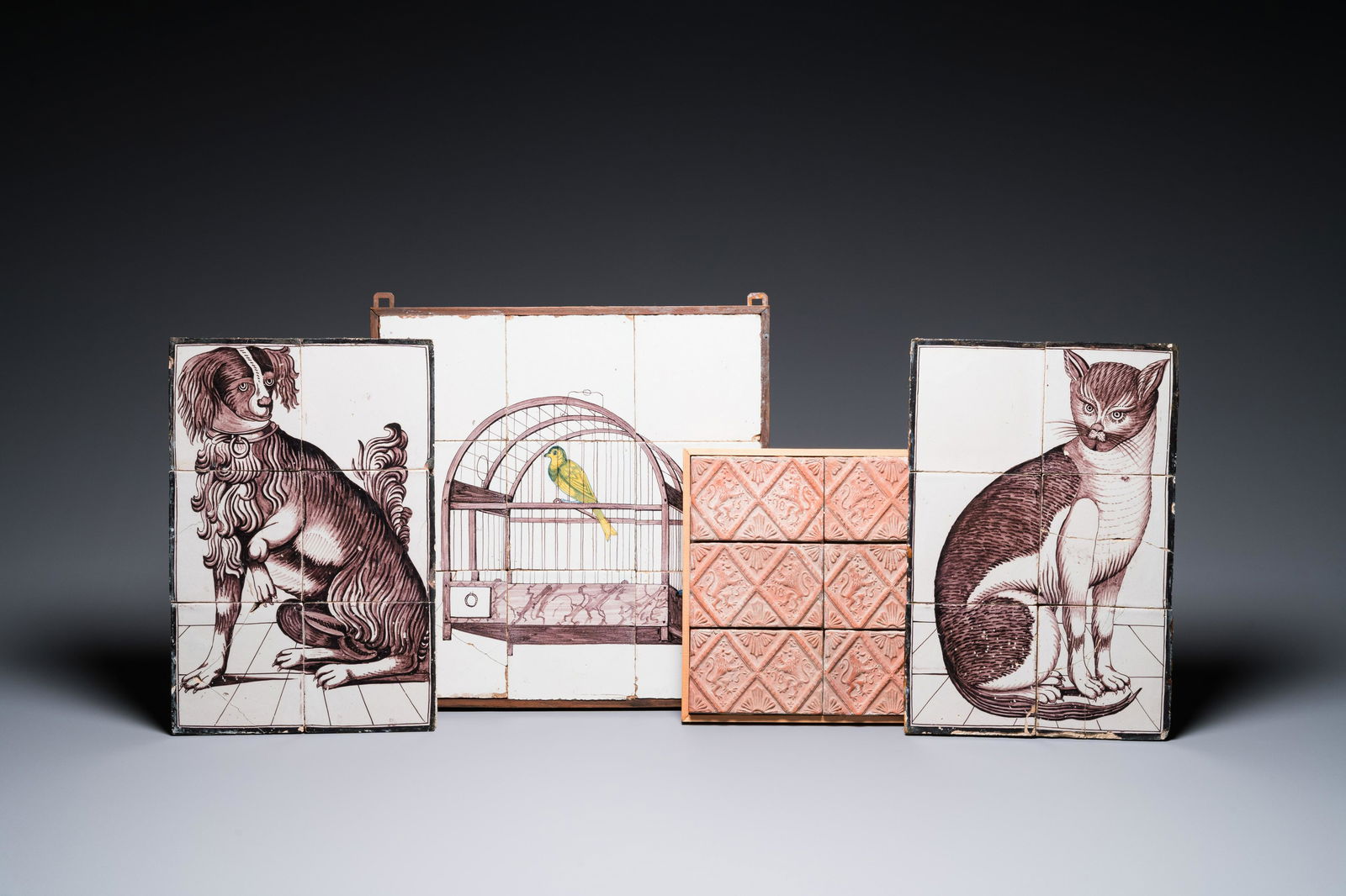 A pair of Dutch Delft manganese 'cat and dog' tile murals, a 'birdcage' mural and a set of stove (1 of 5)