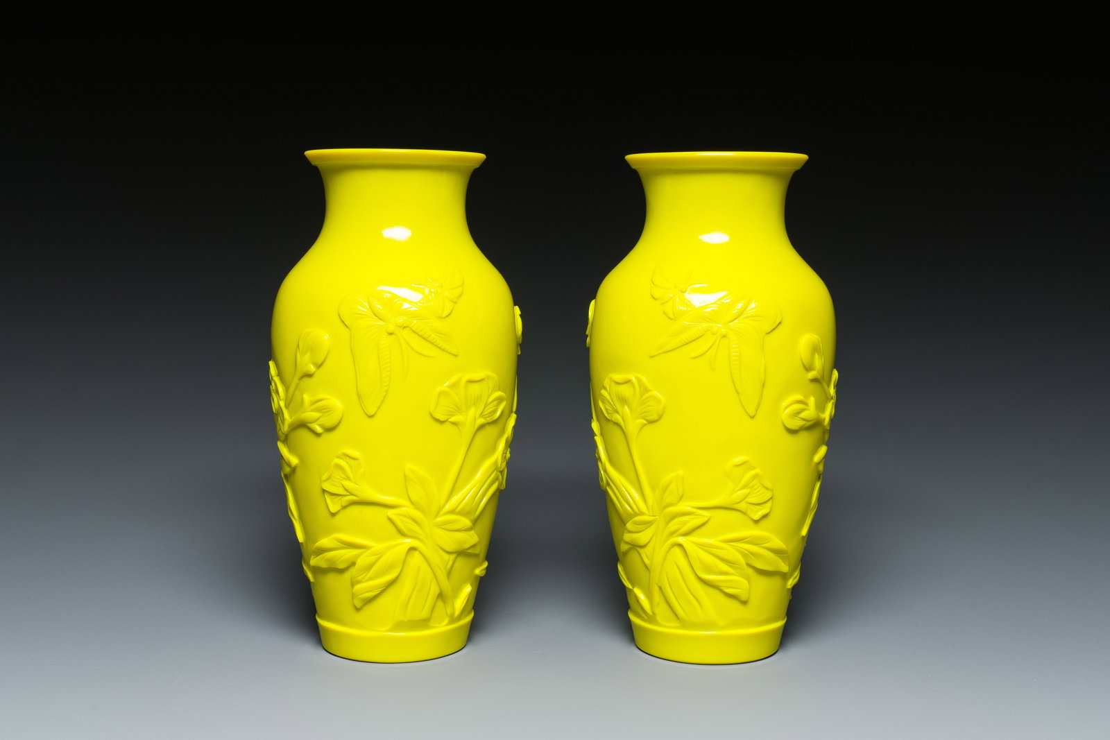 A pair of Chinese yellow Beijing glass vases with butterflies among flowers, Republic: Full title: A pair of Chinese yellow Beijing glass vases with butterflies among flowers, Republic Description: H.: 20 cm Provenance: - The collection of a Belgian connoisseur.