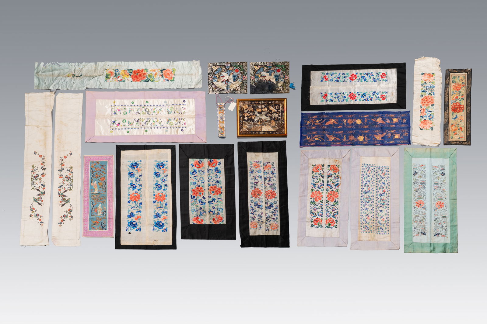 A varied collection of Chinese embroidered silk cloths, a fan-cover and rank badges, 19th C.: A varied collection of Chinese embroidered silk cloths, a fan-cover and rank badges, 19th C. Dim.: 25,3 cm x 21,2 cm (the rank badge, excl. frame) Dim.: 23,5 cm x 22,5 cm (each of the rank badges) Dim