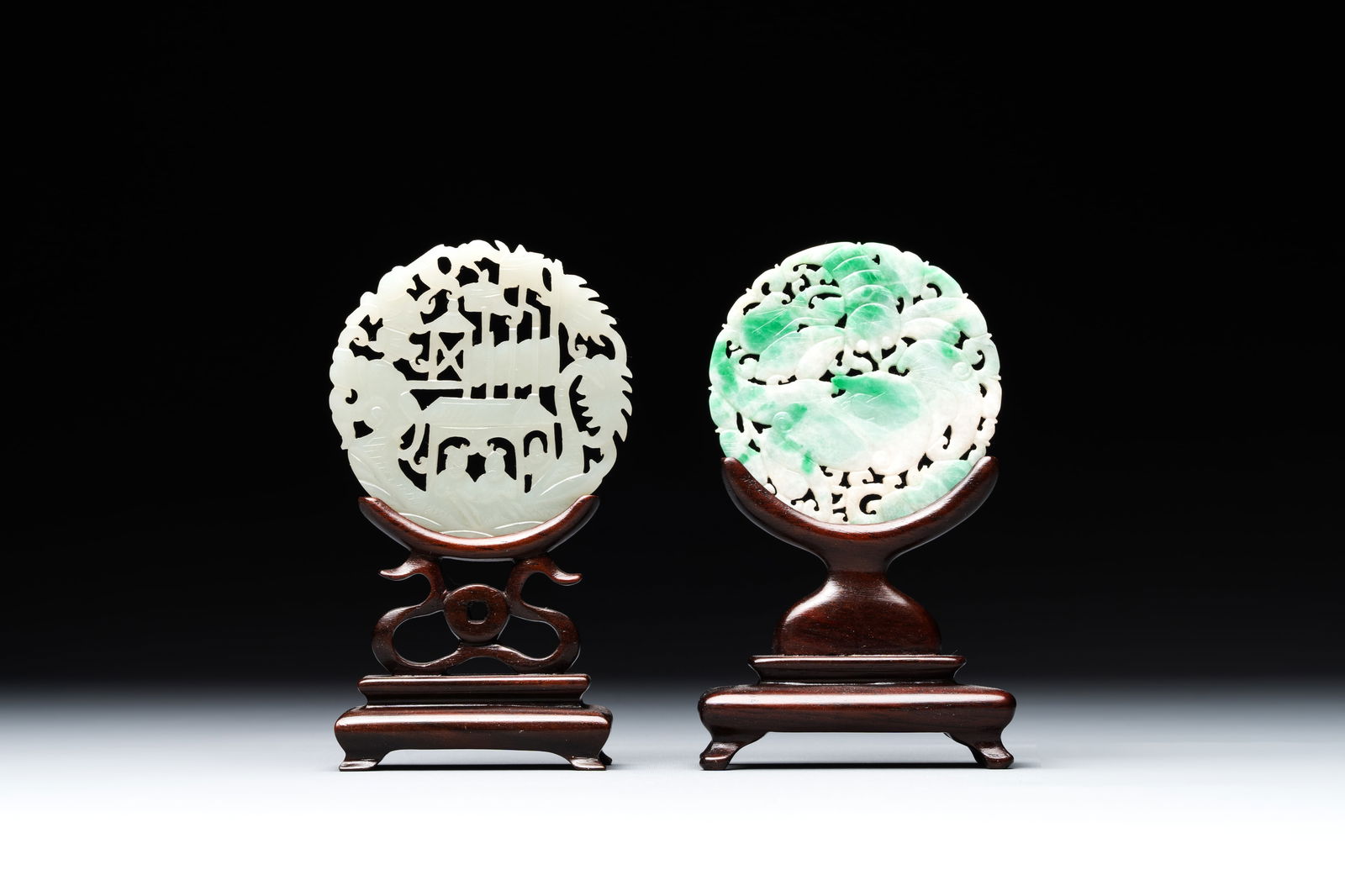 Two Chinese round jade plaques on carved wooden stands, 19th C. (1 of 2)