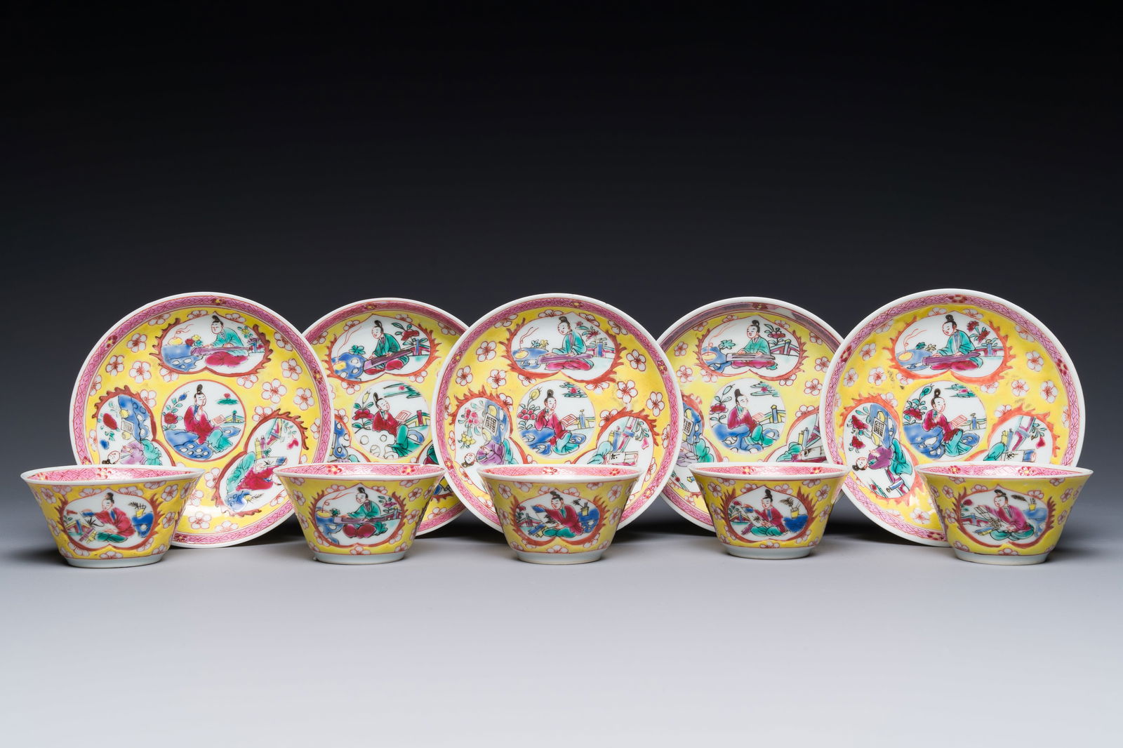 Five Chinese famille rose yellow-ground cups and saucers with 'four arts __' design, Yongzheng (1 of 1)