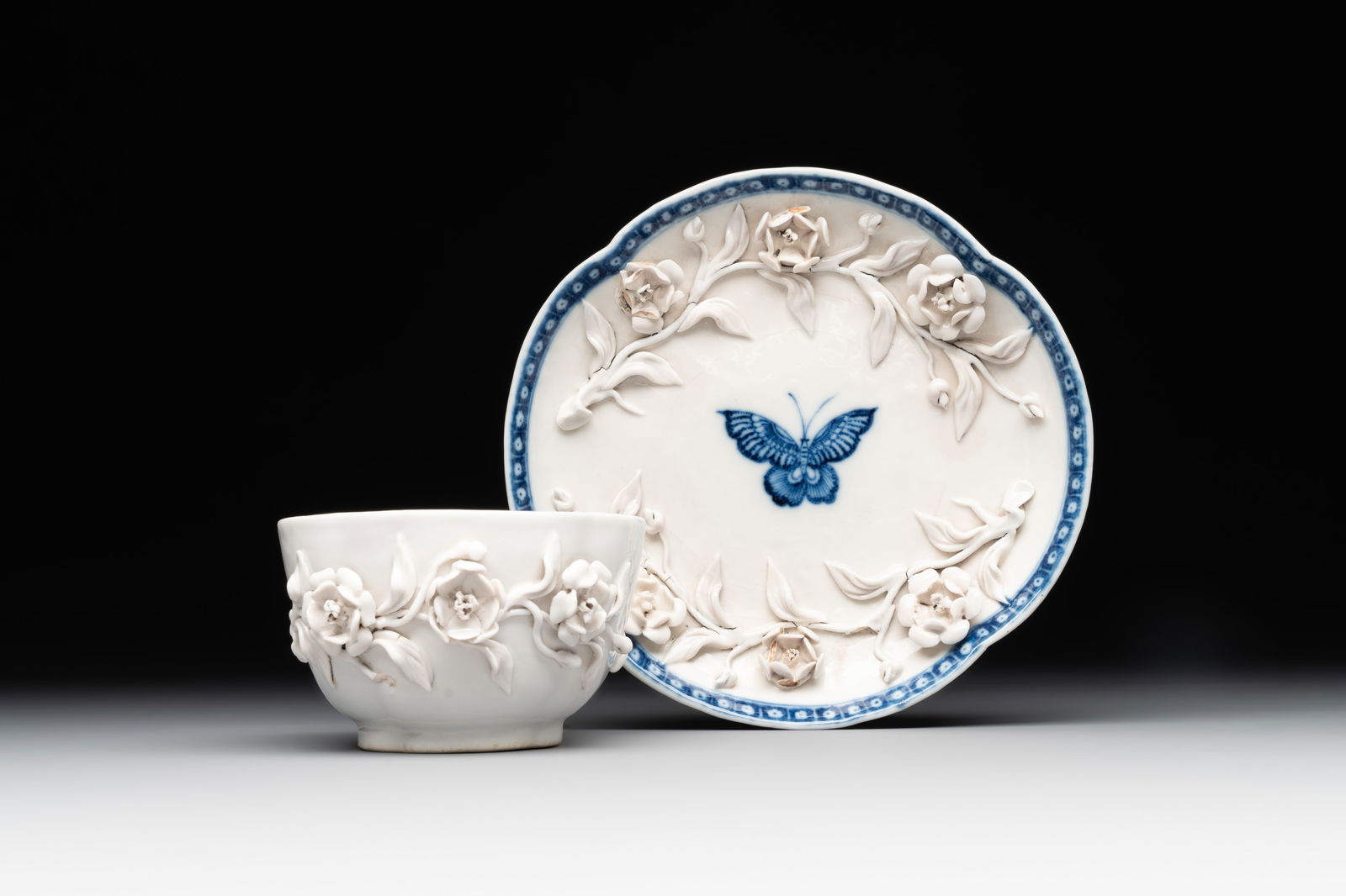 A Chinese blue and white 'butterfly' cup and saucer with applied floral design, Qianlong (1 of 9)