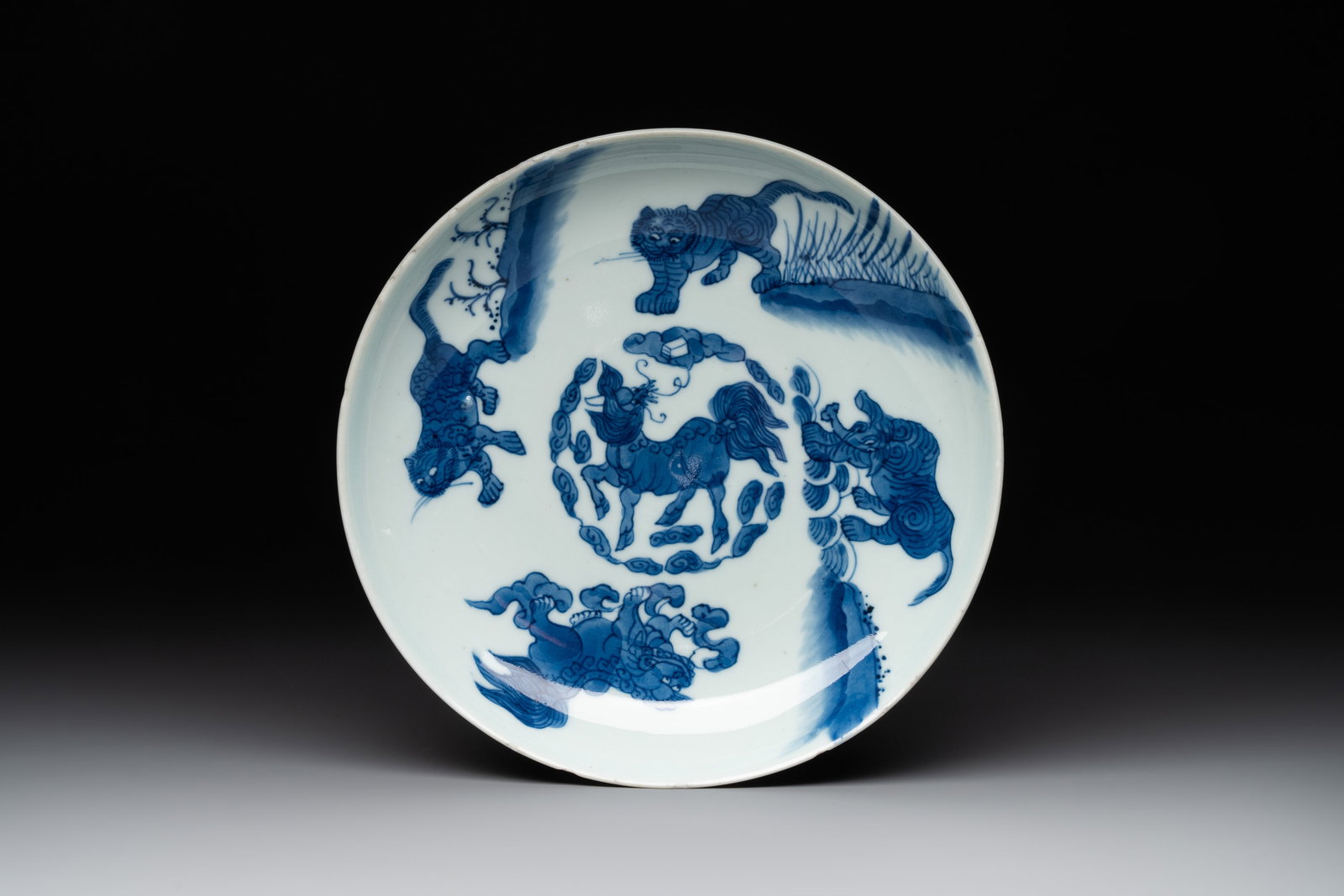 A Chinese blue and white 'mythical beasts' plate, Shunzhi mark and of the period (1 of 2)