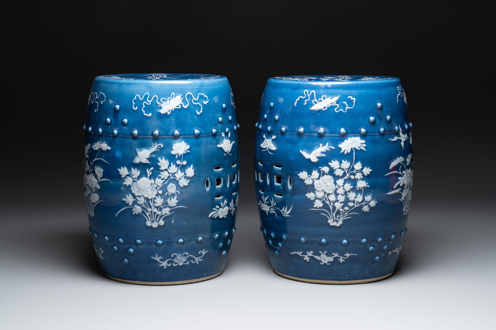 A pair of Chinese white slip-decorated blue-ground garden seats, 19th C. (1 of 6)