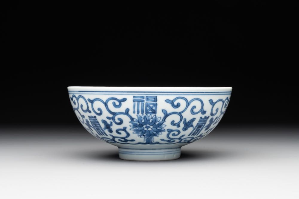 A Chinese blue and white 'fu and shou' bowl with flower scrolls, Yongzheng mark and of the period (1 of 6)