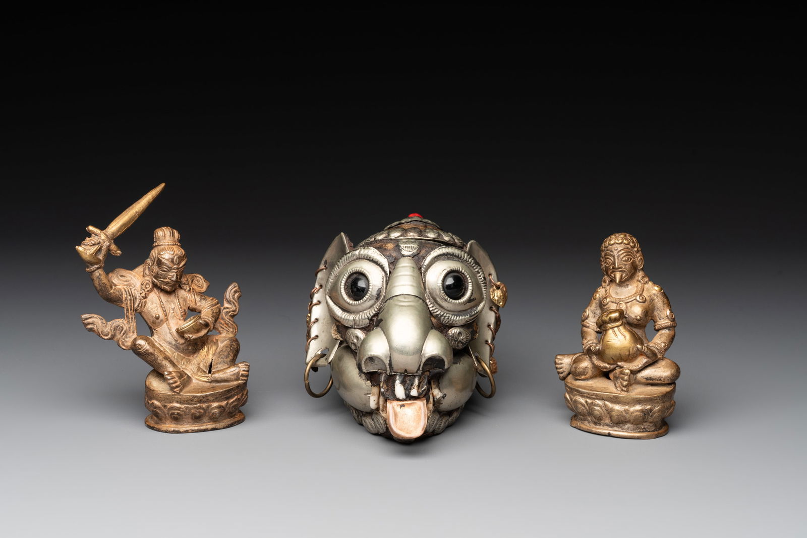 A Tibetan monkey skull or kapala and two Sino-Tibetan bronze figures, 19/20th C. (1 of 14)