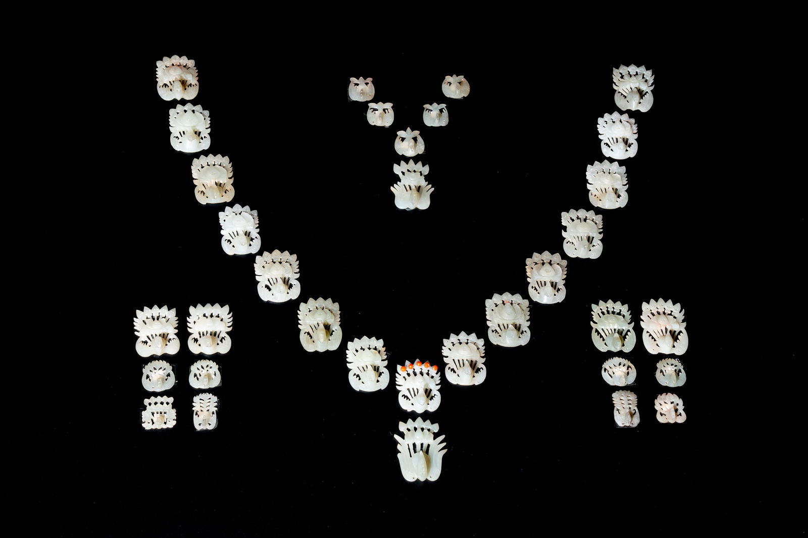 34 Chinese white and celadon jade phoenix-form hat ornaments, 19th C. (1 of 7)