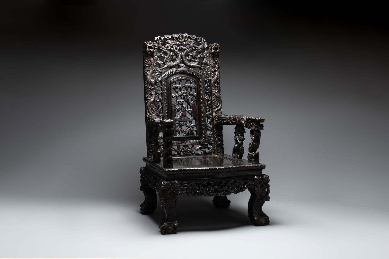 A richly carved Chinese lacquered hongmu armchair, Canton, 19th C. (1 of 7)