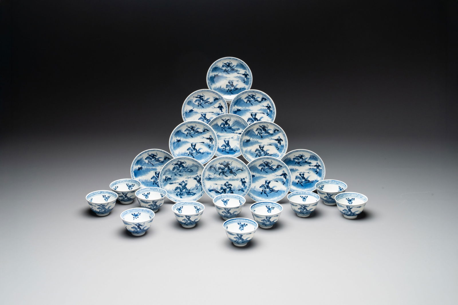 A set of 11 Chinese blue and white 'rabbit hunt' cups and saucers, Qianlong mark, 19th C. (1 of 12)