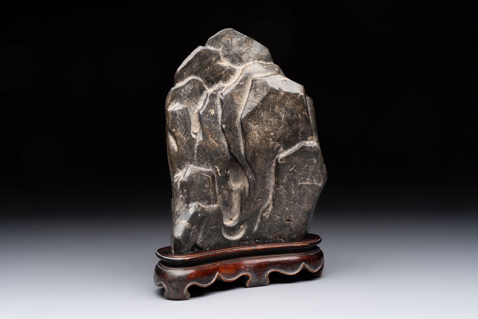 A Chinese Lingbi stone scholar's rock on wooden stand, Yun Tai mark, 19/20th C. (1 of 14)