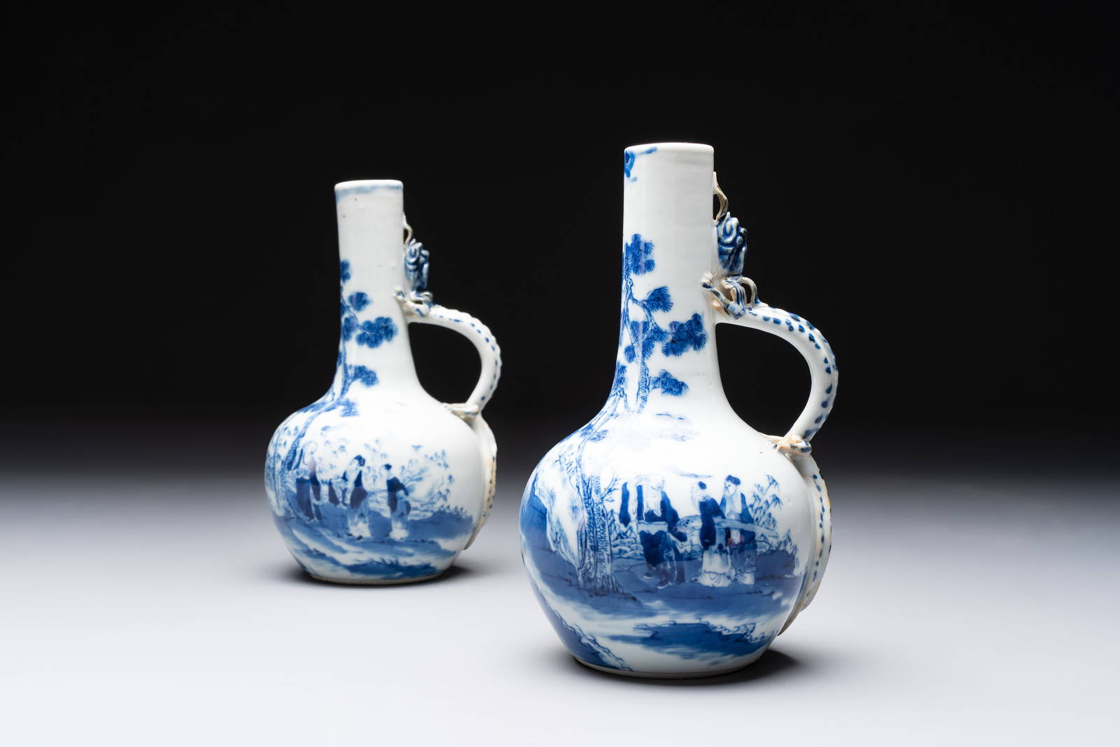 A pair of Chinese blue and white wine jugs with a chilong-form handle, possibly for the Vietnamese