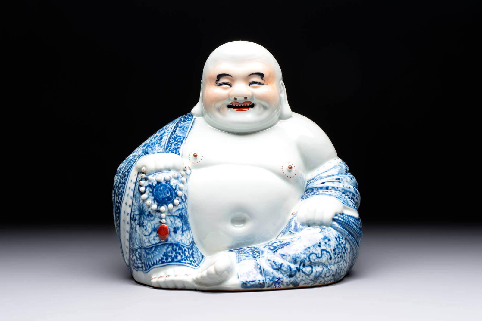A Chinese blue, white and iron-red Milefo Buddha, Zhu Mao Ji mark, 20th C.